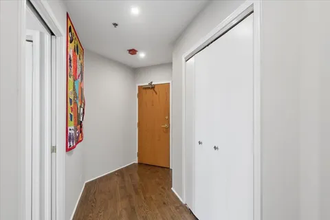 a view of hallway with wooden floor