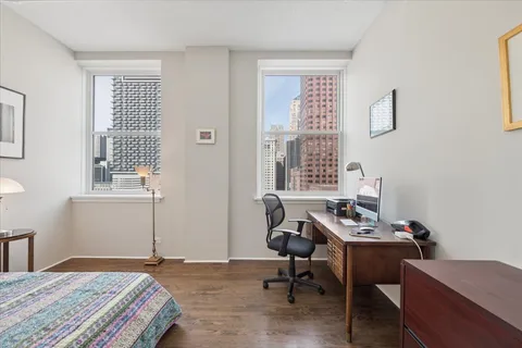 a bedroom that has a bed and a chair in it