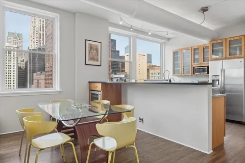 a view of a dining room with furniture and wooden floor