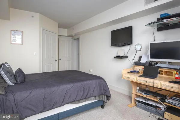 a bedroom with a bed and a flat screen tv
