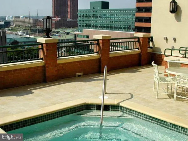 a balcony with a table and chairs