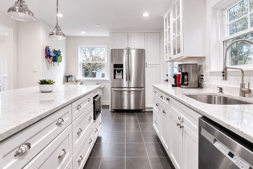 424 Brook Road Milton, MA 02186 - Photo 12 of 41 a kitchen with granite countertop a sink stainless steel appliances a counter space and cabinets