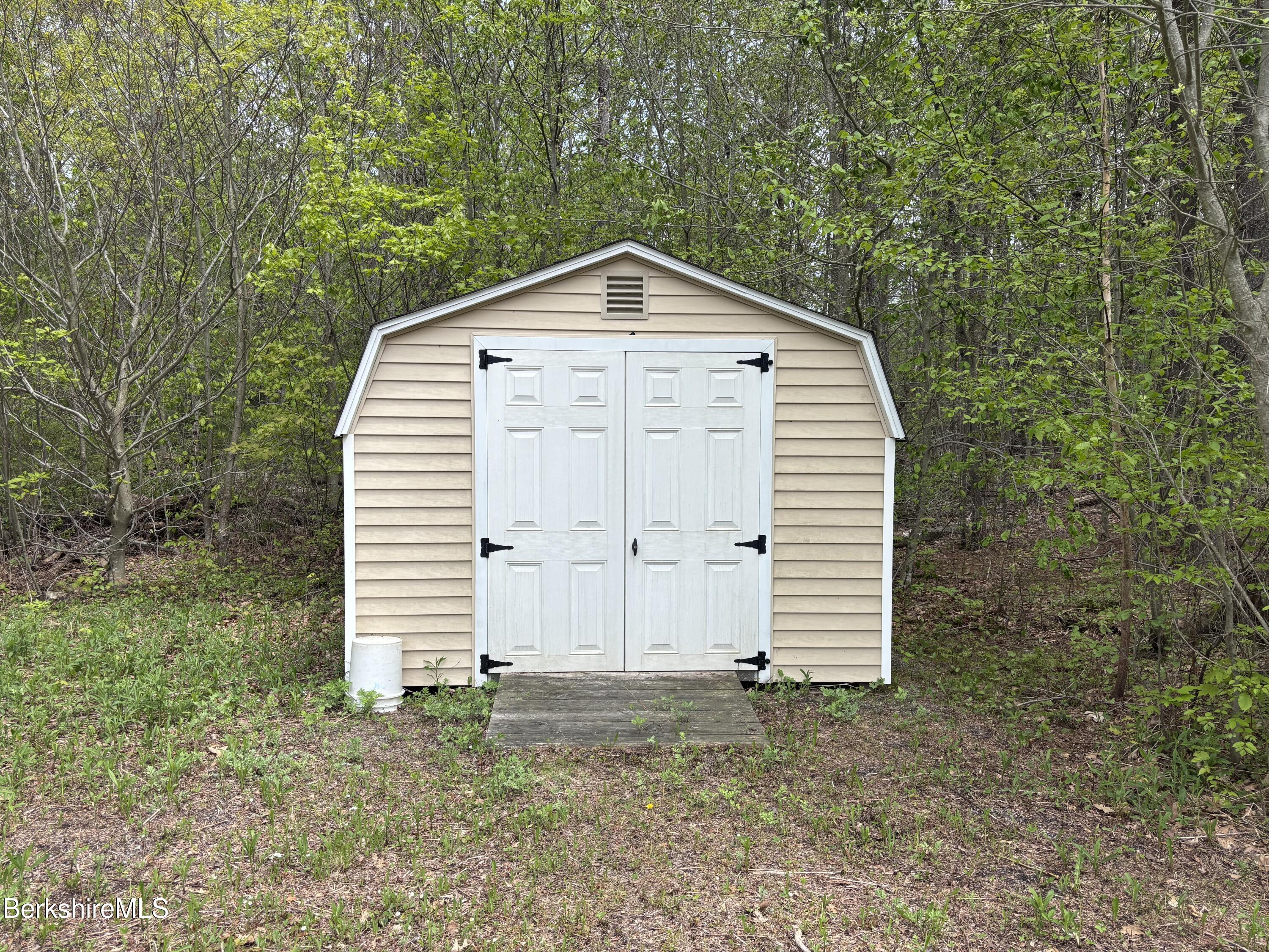 9 South Sandisfield Road Sandisfield, MA 01255 - Photo 8 of 10 a view of a house with a yard and garage