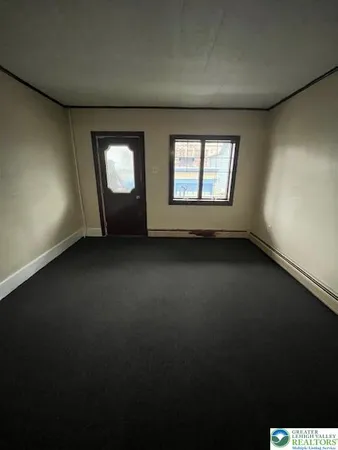 a view of an empty room with windows