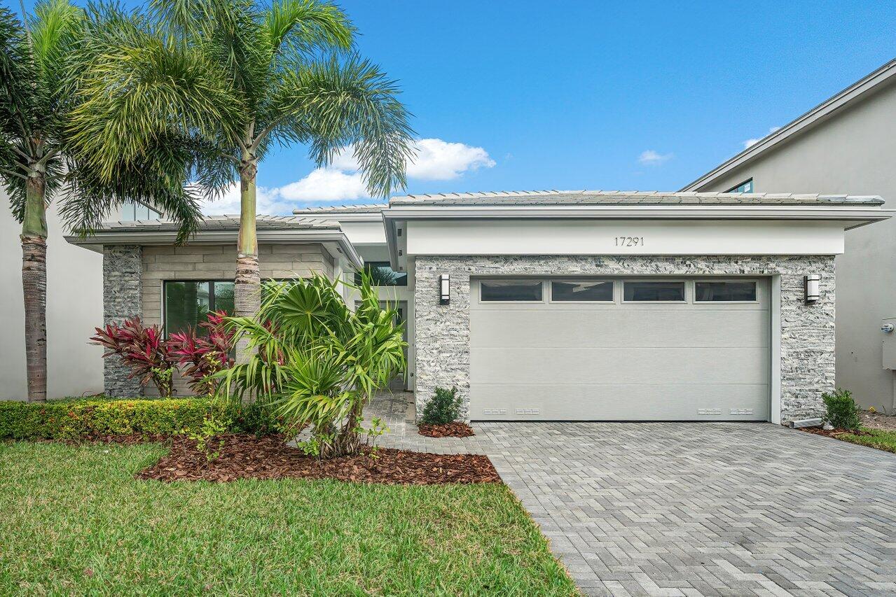 17291 Rainstream Road Boca Raton, FL 33496 - Photo 1 of 21 a front view of house with yard and a garage