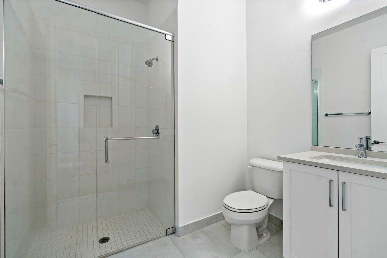 17291 Rainstream Road Boca Raton, FL 33496 - Photo 15 of 21 a bathroom with a granite countertop sink a toilet and shower