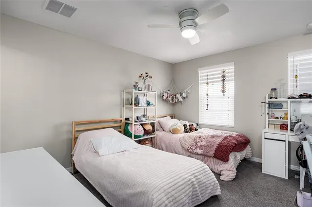 a bedroom with two beds and a chandelier