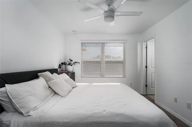 a bedroom with a large bed and a window