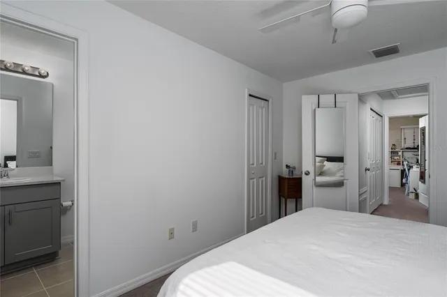 a bedroom with a bed and a bathroom