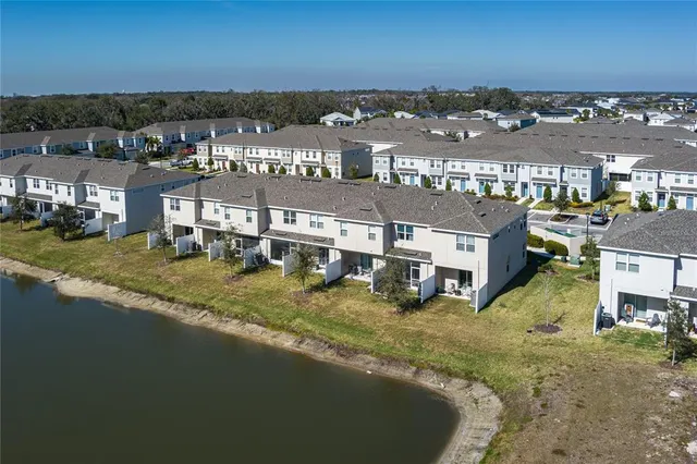 a view of residential houses with outdoor space and ocean view