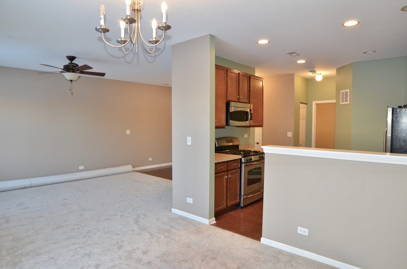 423 Azalea Street Elgin, IL 60124 - Photo 4 of 21 a view of a kitchen with stainless steel appliances a refrigerator and a stove top oven