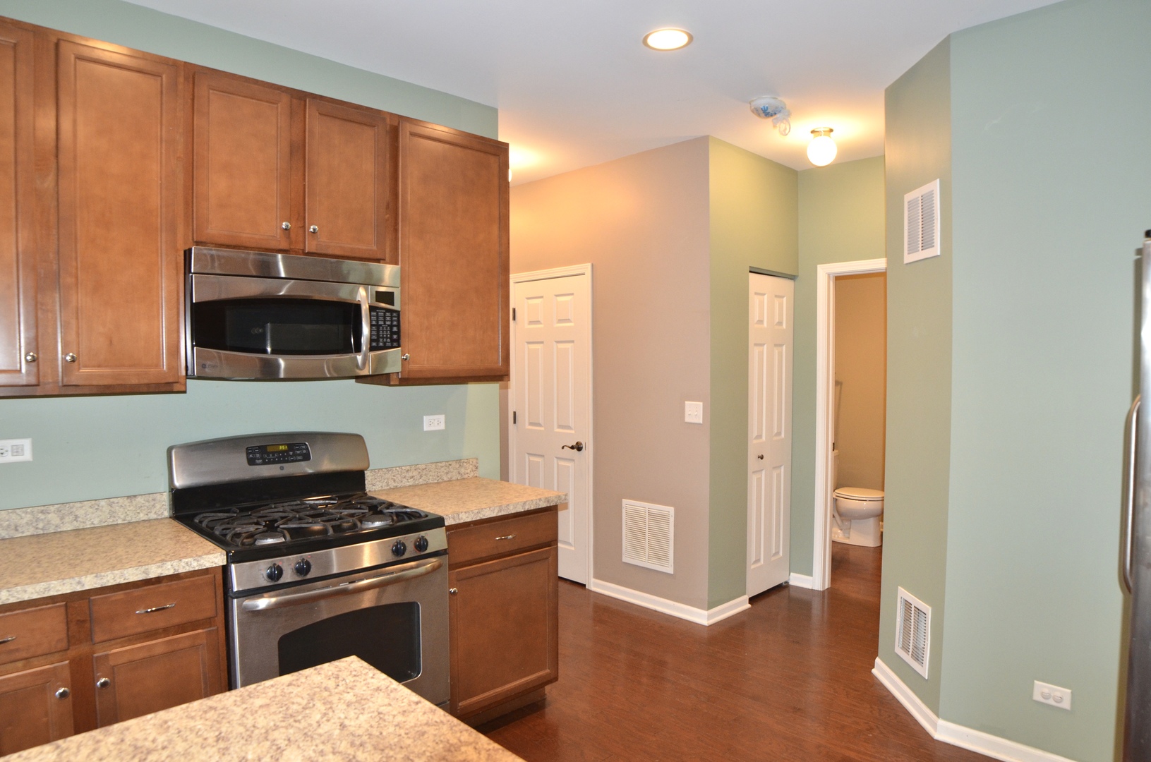 423 Azalea Street Elgin, IL 60124 - Photo 6 of 21 a kitchen with stainless steel appliances a stove and a refrigerator