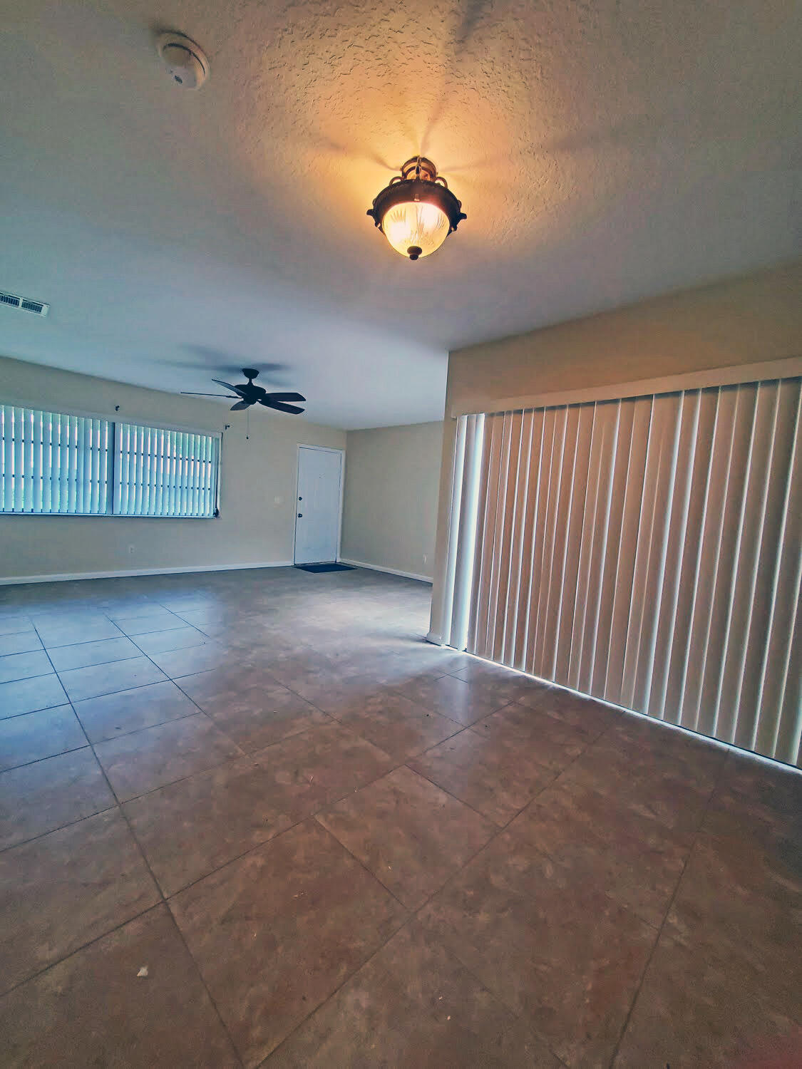 2821 Stoneway Lane, Unit A Fort Pierce, FL 34982 - Photo 3 of 14 a view of a livingroom with a ceiling fan and window