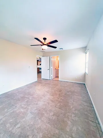 a view of a livingroom with a ceiling fan and window