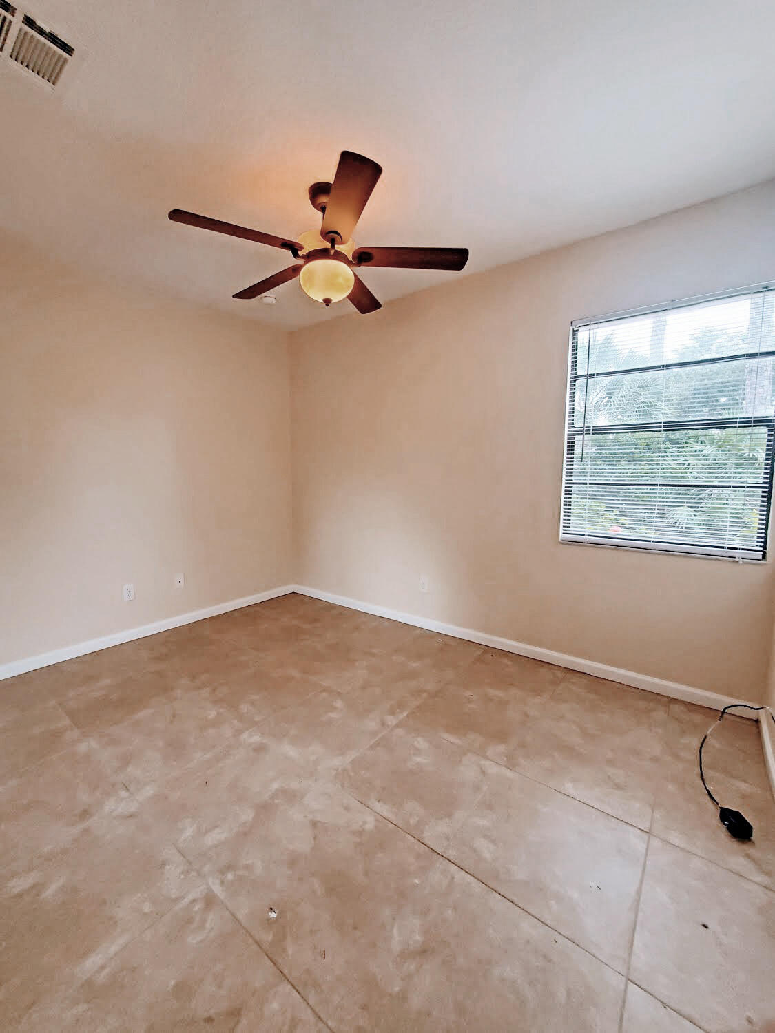 2821 Stoneway Lane, Unit A Fort Pierce, FL 34982 - Photo 8 of 14 a view of an empty room with a window