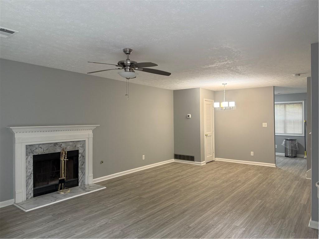 6341 Wedgeview Drive Tucker, GA 30084 - Photo 5 of 26 wooden floor in an empty room with a fireplace