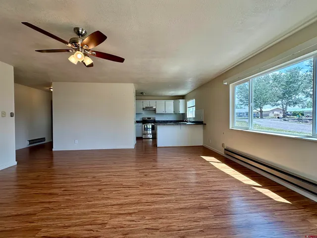 a view of kitchen with microwave and wooden floor