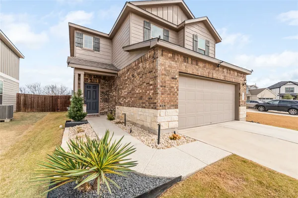 a view of house with backyard and sitting area