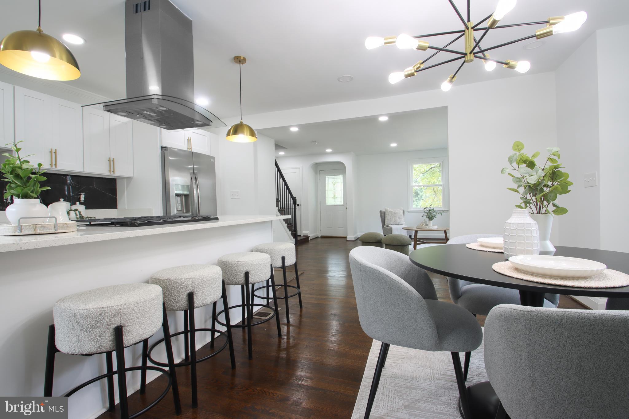 4501 Rokeby Road Baltimore, MD 21229 - Photo 1 of 26 a dining room with furniture and a chandelier