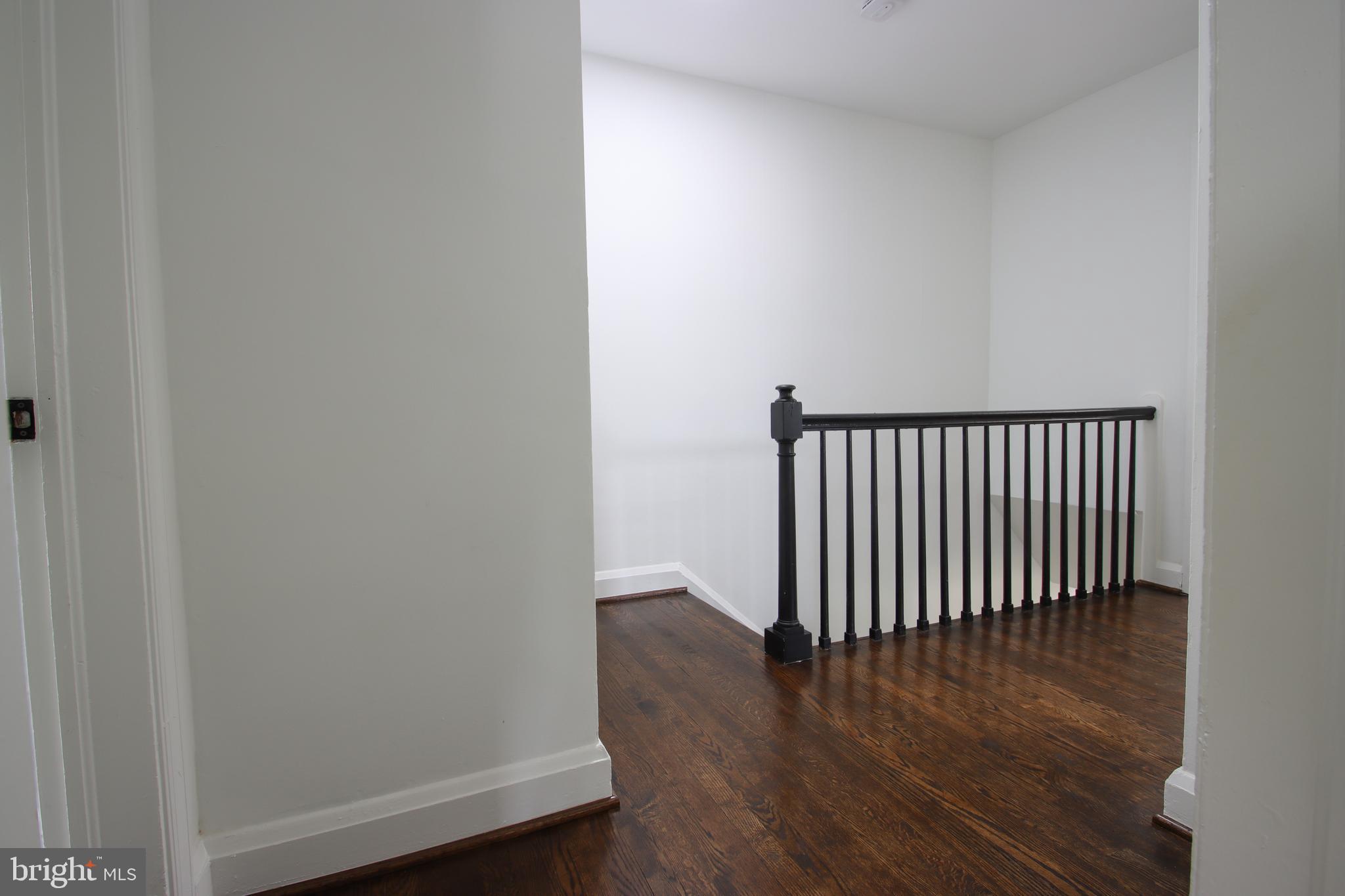 4501 Rokeby Road Baltimore, MD 21229 - Photo 17 of 26 a view of a hallway with wooden floor