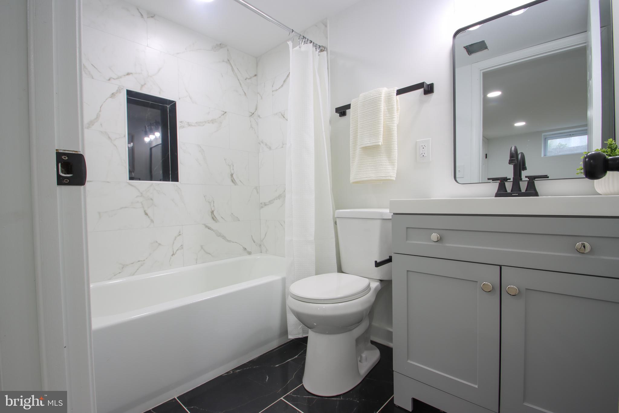 4501 Rokeby Road Baltimore, MD 21229 - Photo 19 of 26 a bathroom with a sink toilet and shower