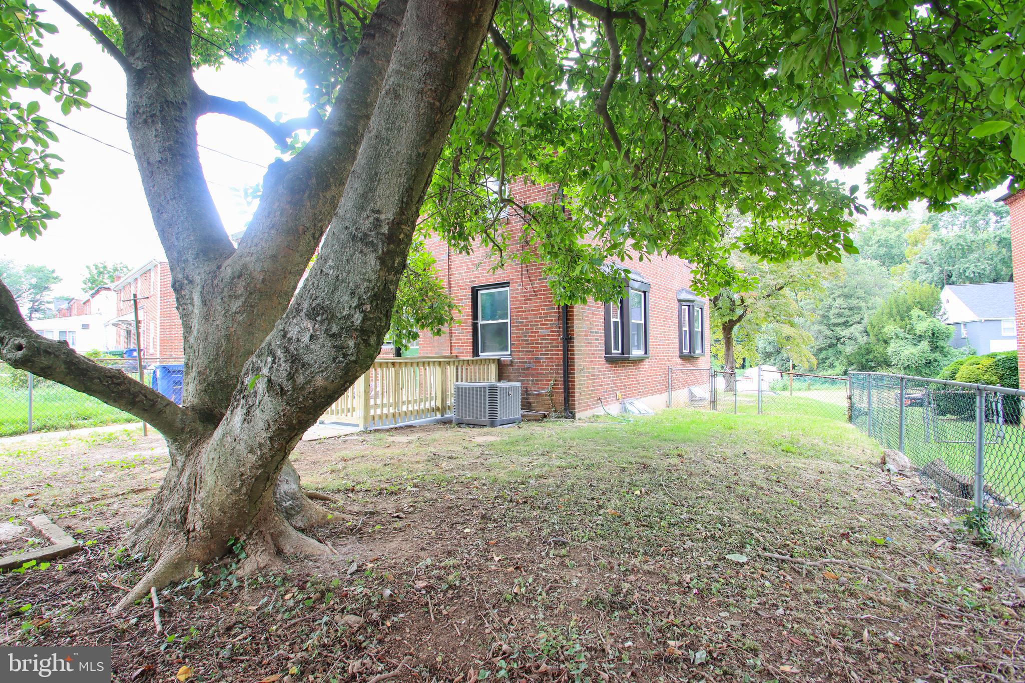 4501 Rokeby Road Baltimore, MD 21229 - Photo 24 of 26 a tree in front of a house with a yard