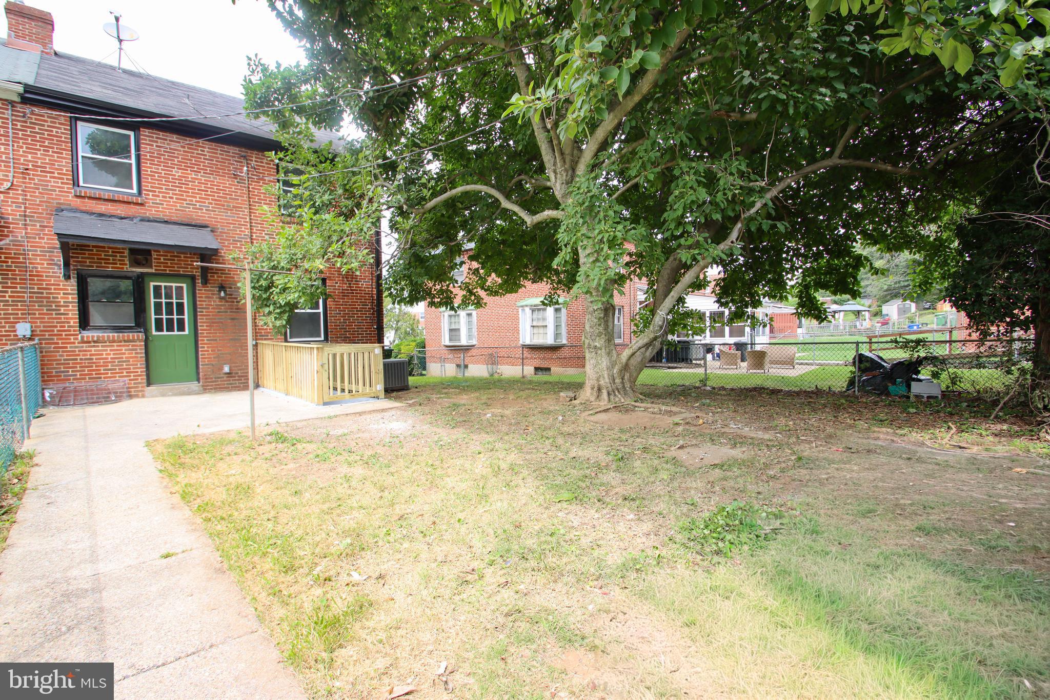 4501 Rokeby Road Baltimore, MD 21229 - Photo 3 of 26 a view of a backyard with large trees