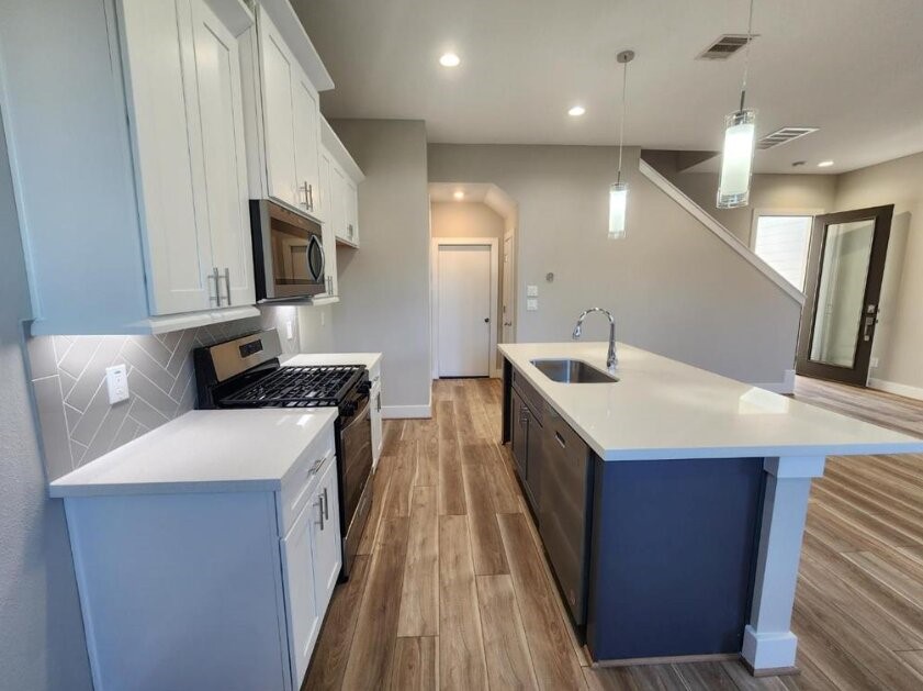 3206 Bostic Street Houston, TX 77093 - Photo 11 of 28 a kitchen with a sink and a refrigerator