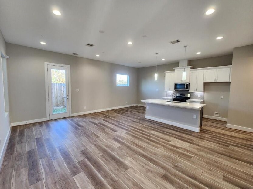 3206 Bostic Street Houston, TX 77093 - Photo 7 of 28 a view of kitchen with kitchen island granite countertop cabinets and wooden floor