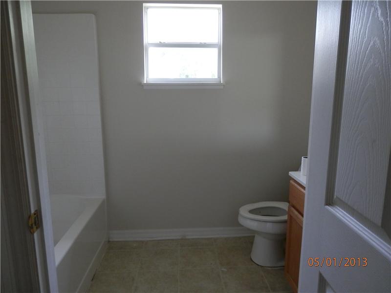 801 Roseland Road Sebastian, FL 32958 - Photo 4 of 11 a bathroom with a toilet and a window