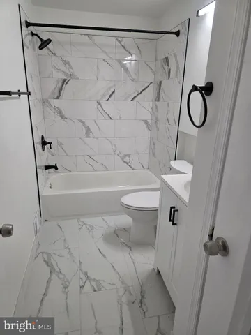 a bathroom with a shower a toilet and sink