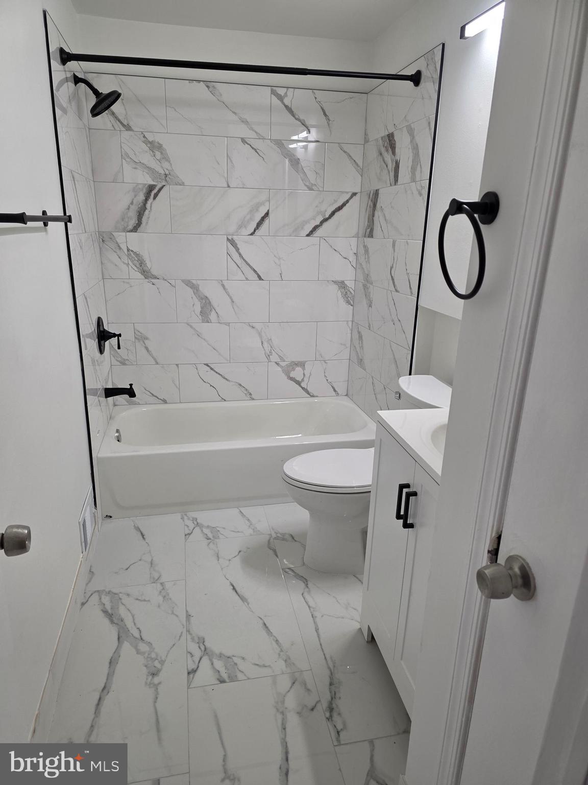 307 Arch Street, Unit 3B Philadelphia, PA 19106 - Photo 7 of 9 a bathroom with a shower a toilet and sink