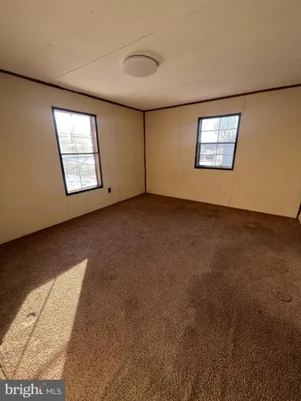 a view of an empty room with windows