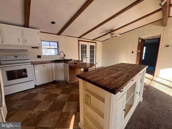 a kitchen with a stove sink and cabinets