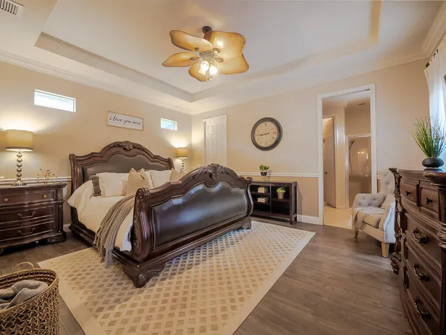 a bedroom with a bed and a chandelier