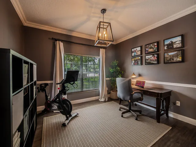 a view of a livingroom with workspace and a window