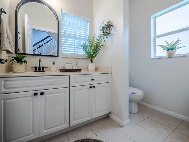 a bathroom with a toilet sink and mirror