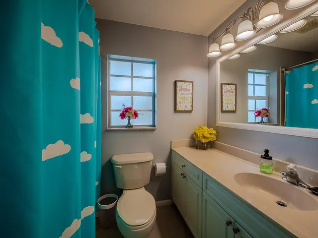 a bathroom with a toilet sink and mirror