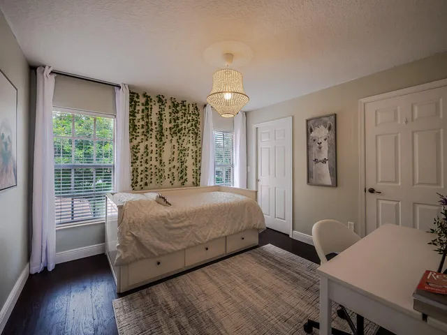 a bedroom with a bed and wooden floor