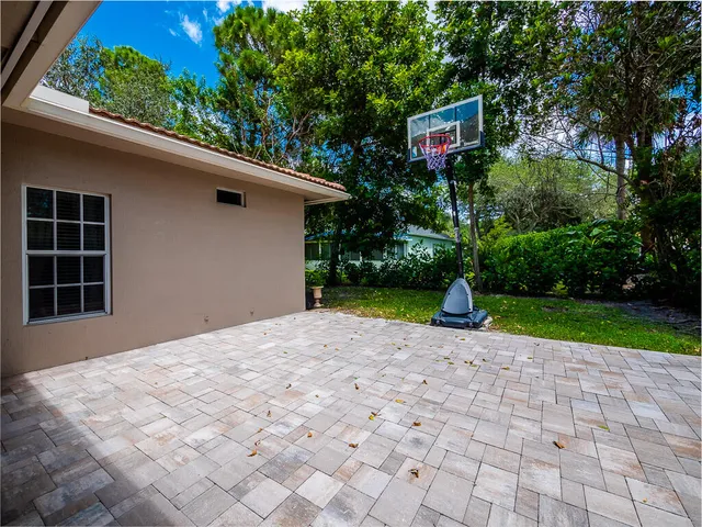 a pathway of a house with a yard