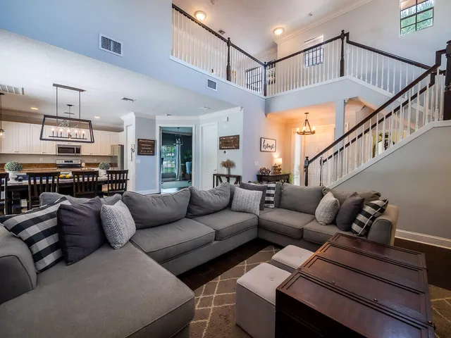 a living room with furniture and a ceiling fan