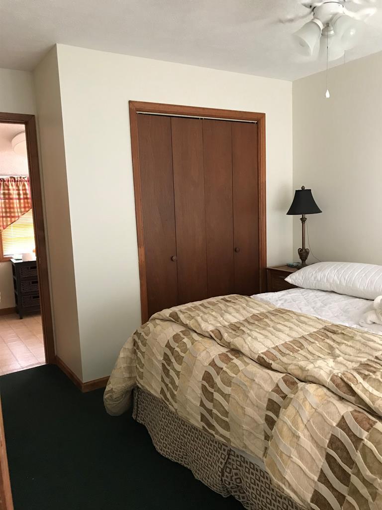 339 Bluegill Road Eatonton, GA 31024 - Photo 15 of 20 a bedroom with a bed and wooden floor