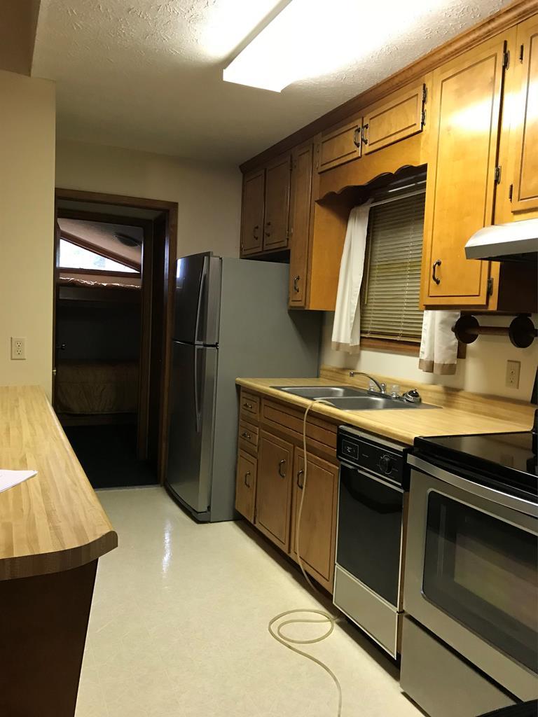 339 Bluegill Road Eatonton, GA 31024 - Photo 8 of 20 a kitchen with a sink and a refrigerator