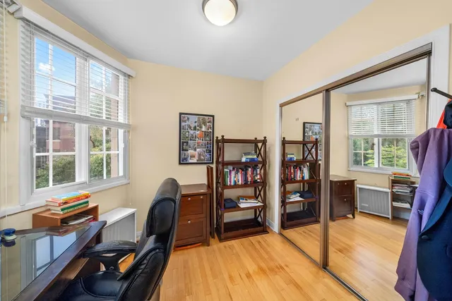 a view of a workspace with furniture and a window