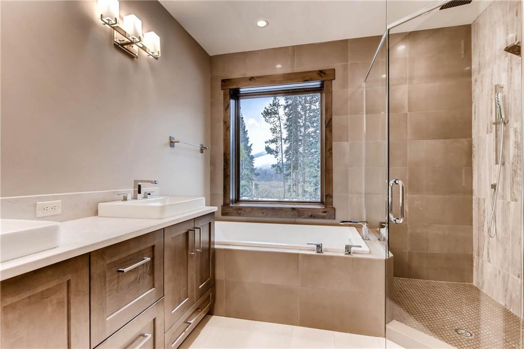 11 Independence Road Keystone, CO 80435 - Photo 14 of 24 a bathroom with a tub sink and mirror
