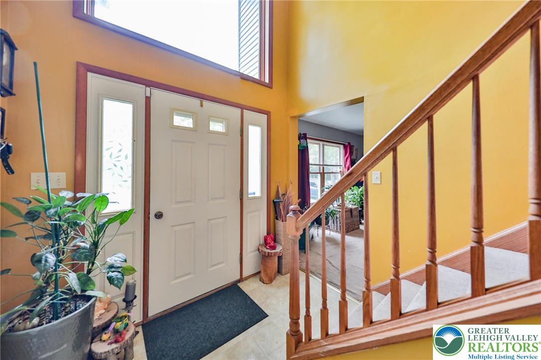 4608 Pine Ridge Drive West Bushkill, PA 18324 - Photo 8 of 62 A spacious entry, with an elegant staircase and warm, inviting ambiance, welcomes you home.