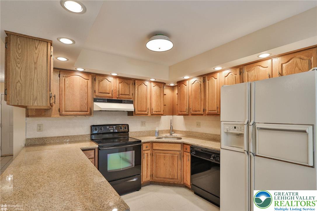 4059 Wedgewood Road Allentown, PA 18104 - Photo 18 of 50 a kitchen with a refrigerator a stove top oven and a sink