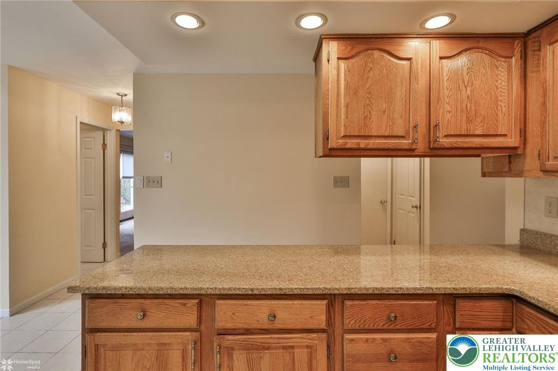 4059 Wedgewood Road Allentown, PA 18104 - Photo 23 of 50 a bathroom with a granite countertop sink and white cabinets