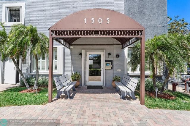 a front view of a house with garden and seating area