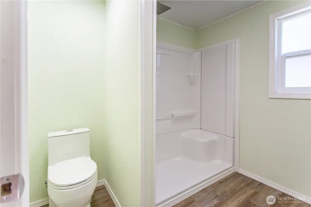 a bathroom with a granite countertop toilet and a shower